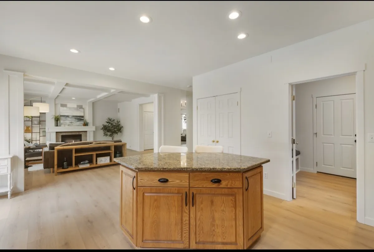 Open-concept kitchen and living area with recessed lighting installed by Royal Electric