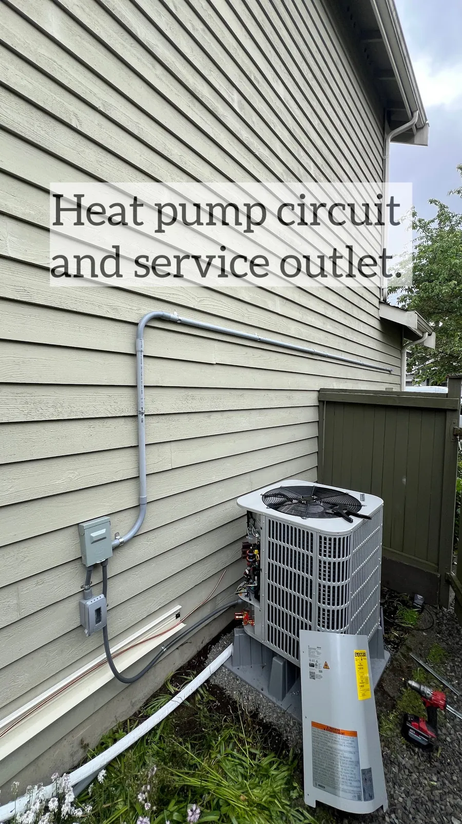 Heat pump condenser with disconnect switch and service outlet