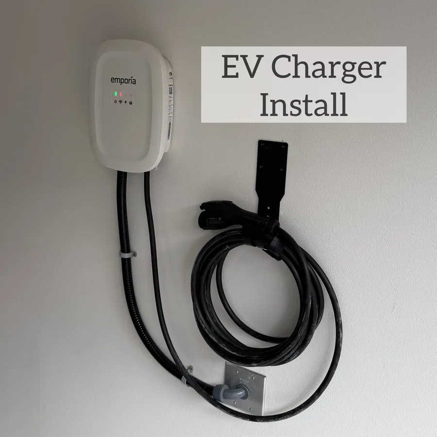 Wall-mounted EV charger with neatly coiled cable and conduit