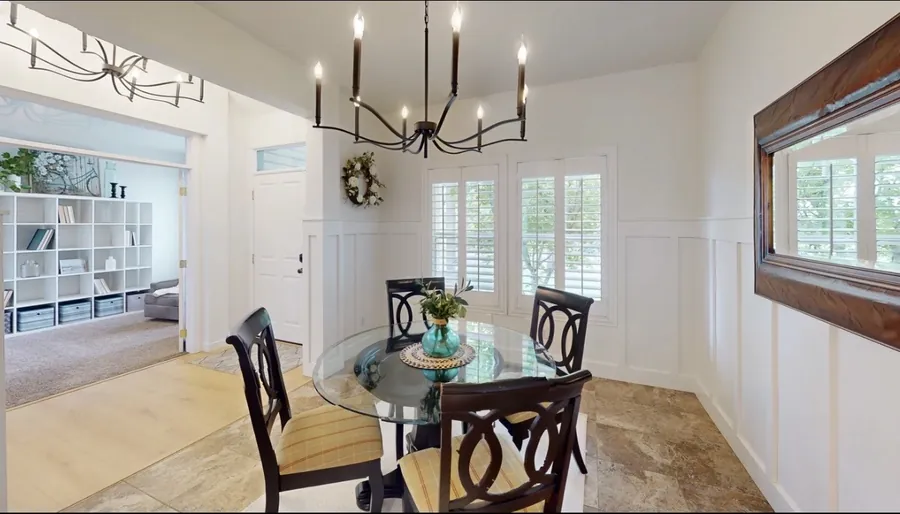 Black multi-arm chandelier above a dining room table